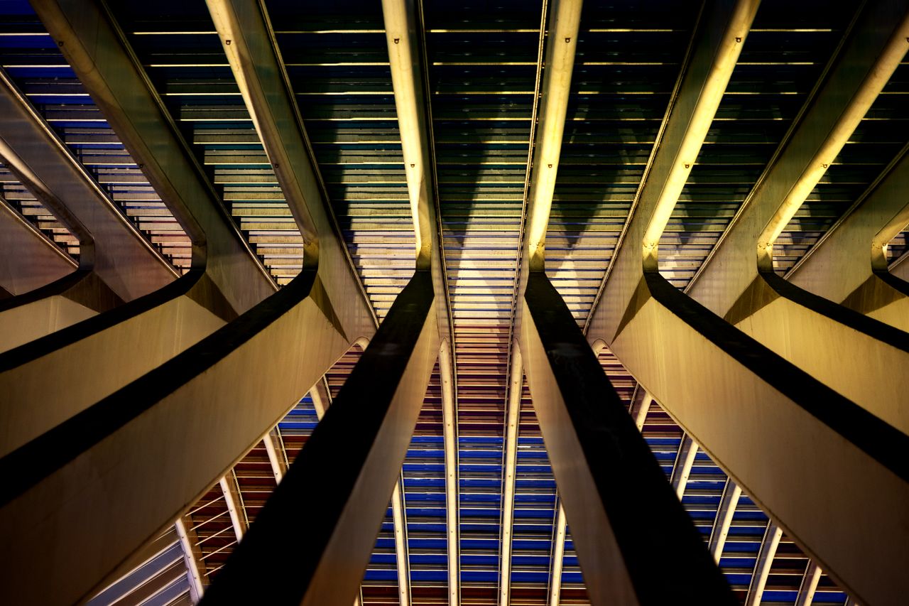 pexels photo 29122162 Abstract view of modern architecture columns in Liège, Belgium, highlighted at night.